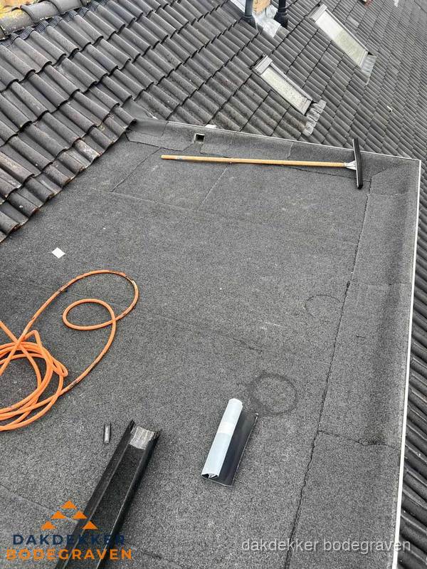 Plat dak reparatie met gereedschap en loodstroken in Bodegraven Plat dak reparatie met gereedschap en loodstroken in Bodegraven